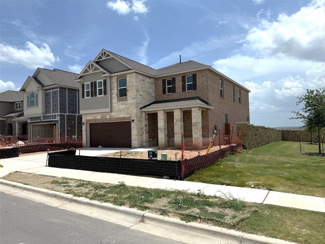4805 Mozzafiato Ln, Round Rock, TX 78665 - view of front of house featuring an attached garage, stone siding, and concrete driveway