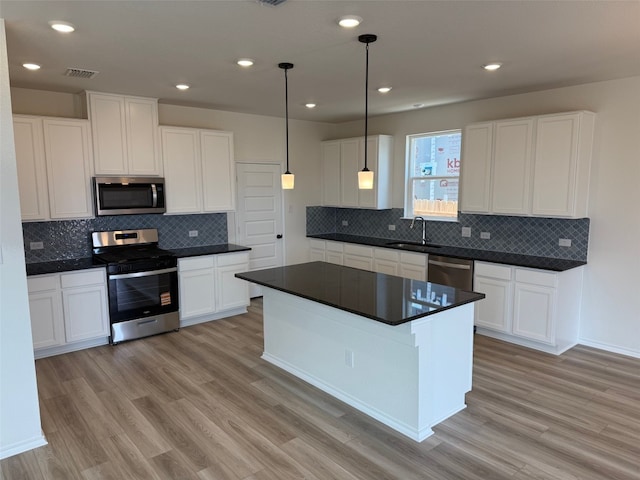 4805 Mozzafiato Ln, Round Rock, TX 78665 - kitchen with appliances with stainless steel finishes, dark countertops, tasteful backsplash, and recessed lighting