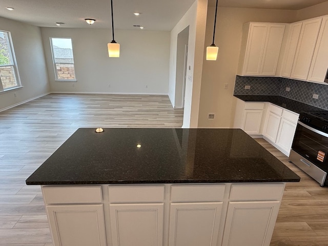 4805 Mozzafiato Ln, Round Rock, TX 78665 - kitchen with stainless steel range with gas cooktop, light wood-type flooring, open floor plan, and recessed lighting