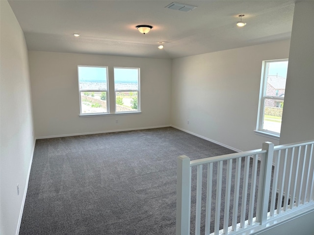 4805 Mozzafiato Ln, Round Rock, TX 78665 - unfurnished room with plenty of natural light and dark carpet
