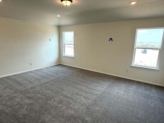 4805 Mozzafiato Ln, Round Rock, TX 78665 - spare room featuring dark carpet and baseboards