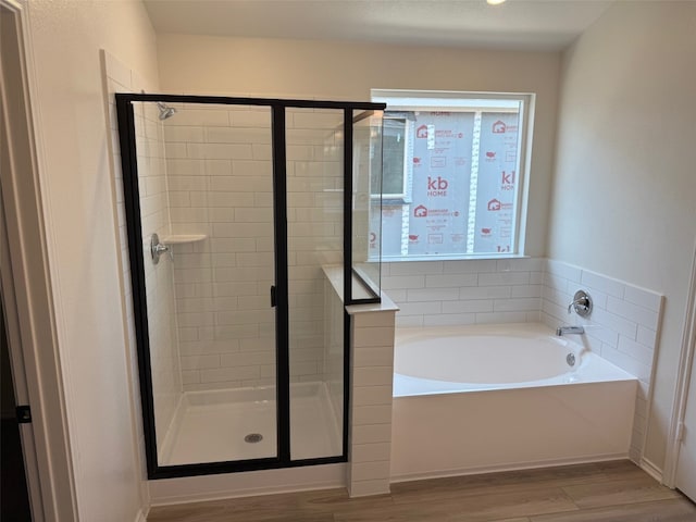 4805 Mozzafiato Ln, Round Rock, TX 78665 - full bathroom with wood finished floors, a garden tub, and a shower stall