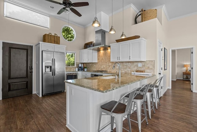 4910 Owen Ln, Temple, TX 76502 - kitchen featuring stainless steel appliances, extractor fan, a high ceiling, a peninsula, and light stone counters