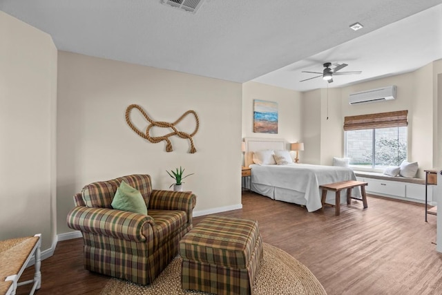 4910 Owen Ln, Temple, TX 76502 - bedroom featuring a wall mounted air conditioner, wood finished floors, and ceiling fan