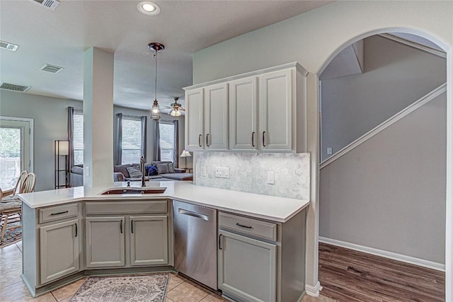 2712 Kickapoo Cavern Dr, Pflugerville, TX 78660 - kitchen with dishwasher, gray cabinetry, a peninsula, light countertops, and open floor plan