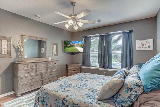 2712 Kickapoo Cavern Dr, Pflugerville, TX 78660 - bedroom featuring light wood finished floors, ceiling fan, and a textured ceiling