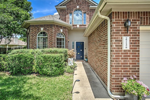 2712 Kickapoo Cavern Dr, Pflugerville, TX 78660 - entrance to property featuring brick siding, a garage, and a shingled roof