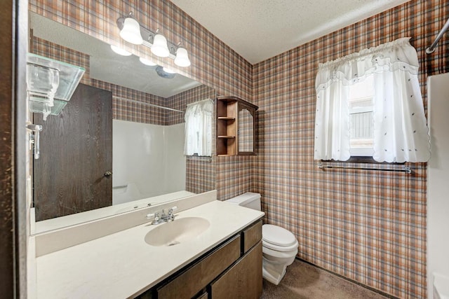 6606 Lancret Hill Dr, Austin, TX 78745 - full bath featuring a shower, vanity, a textured ceiling, and tile walls