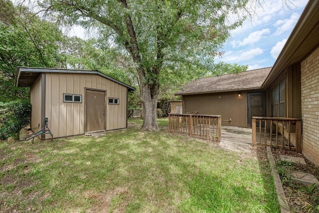 6606 Lancret Hill Dr, Austin, TX 78745 - view of grassy yard featuring a storage unit and a deck