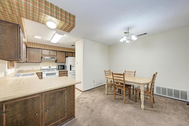 6606 Lancret Hill Dr, Austin, TX 78745 - kitchen featuring white appliances, a chandelier, under cabinet range hood, light colored carpet, and dark brown cabinetry
