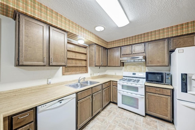 6606 Lancret Hill Dr, Austin, TX 78745 - kitchen with white appliances, under cabinet range hood, a textured ceiling, open shelves, and wallpapered walls