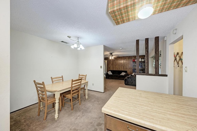 6606 Lancret Hill Dr, Austin, TX 78745 - dining area with light colored carpet, ceiling fan, a chandelier, and a textured ceiling
