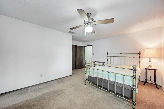 6606 Lancret Hill Dr, Austin, TX 78745 - bedroom featuring carpet flooring, a textured ceiling, and a ceiling fan