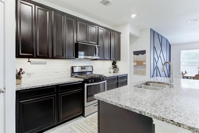 114 Creek Hollow Dr, Hutto, TX 78634 - kitchen featuring stainless steel appliances, tasteful backsplash, and light stone counters