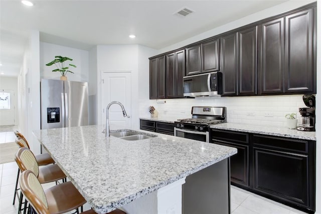 114 Creek Hollow Dr, Hutto, TX 78634 - kitchen with appliances with stainless steel finishes, light tile patterned floors, light stone countertops, and recessed lighting
