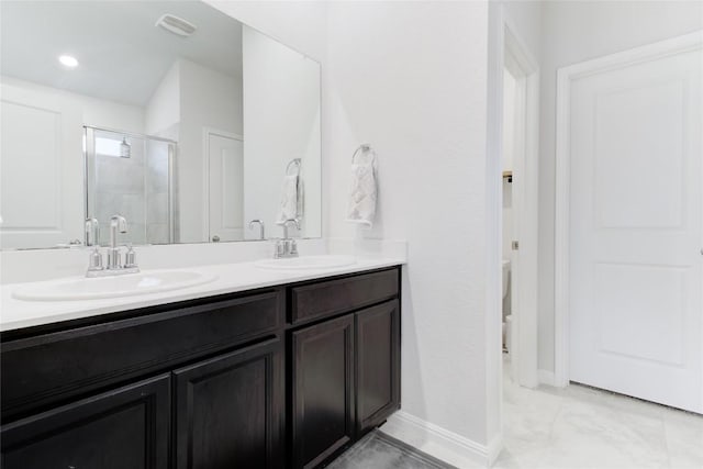 114 Creek Hollow Dr, Hutto, TX 78634 - bathroom featuring double vanity, a shower stall, and marble look tile flooring