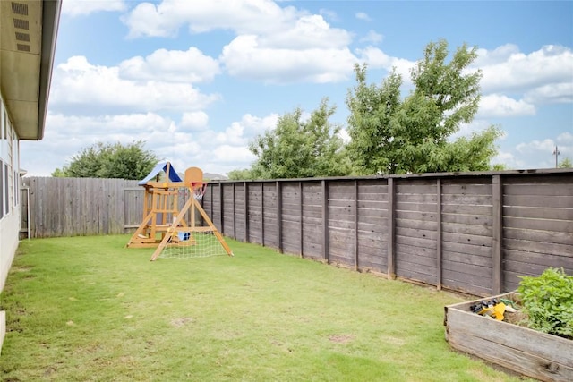 114 Creek Hollow Dr, Hutto, TX 78634 - fenced backyard with a playground and a vegetable garden