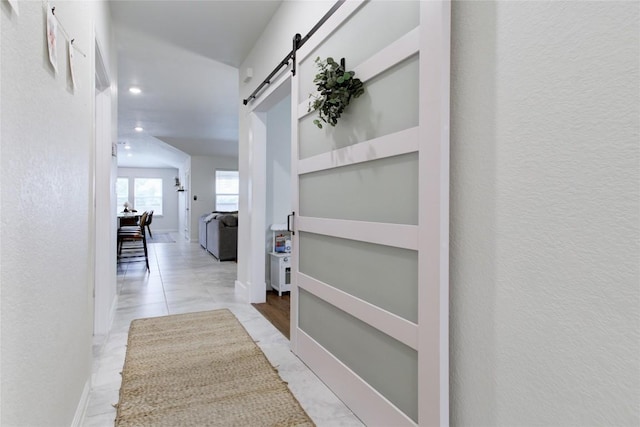 114 Creek Hollow Dr, Hutto, TX 78634 - hall featuring a barn door and recessed lighting
