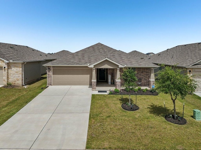 111 Krause Springs Dr, Hutto, TX 78634 - view of front facade with an attached garage, concrete driveway, brick siding, a front lawn, and roof with shingles