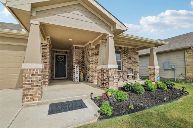 111 Krause Springs Dr, Hutto, TX 78634 - doorway to property featuring covered porch, brick siding, and a garage