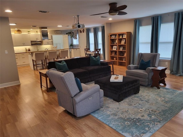 236 Makaha Dr, Bastrop, TX 78602 - living room featuring healthy amount of natural light, a ceiling fan, light wood-style floors, and recessed lighting