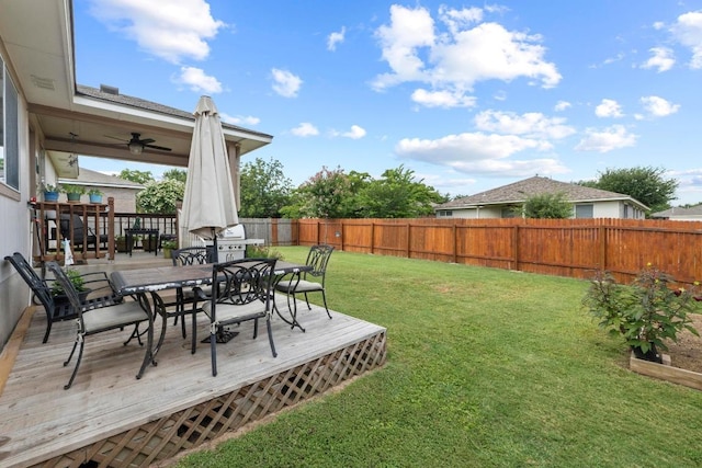1111 Whitley Dr, Leander, TX 78641 - fenced backyard with outdoor dining space, a wooden deck, and ceiling fan