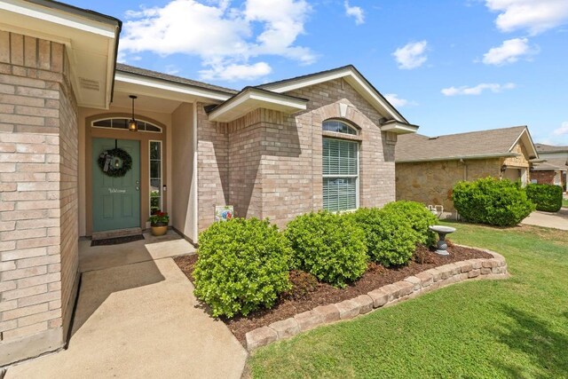 1111 Whitley Dr, Leander, TX 78641 - entrance to property featuring a lawn and brick siding