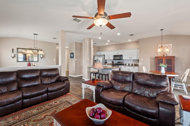 1111 Whitley Dr, Leander, TX 78641 - living room featuring lofted ceiling, wood finished floors, a ceiling fan, a chandelier, and recessed lighting