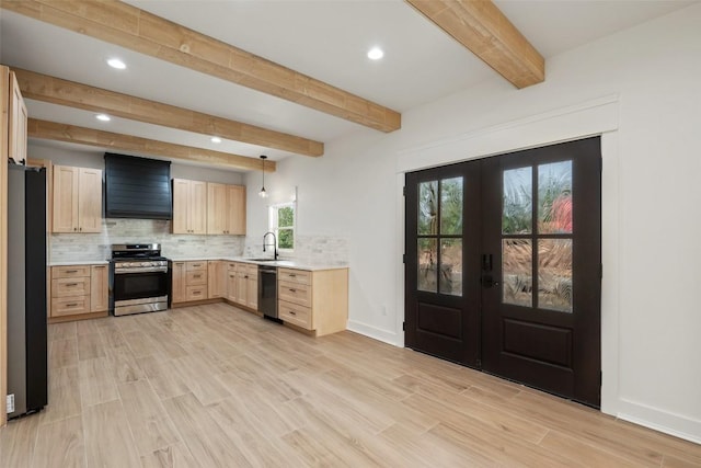 280 Bali Hai Ln, Bastrop, TX 78602 - kitchen featuring appliances with stainless steel finishes, wall chimney exhaust hood, light brown cabinets, french doors, and light countertops