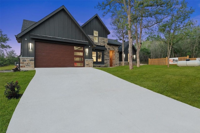 280 Bali Hai Ln, Bastrop, TX 78602 - view of front of house featuring board and batten siding, stone siding, concrete driveway, and an attached garage