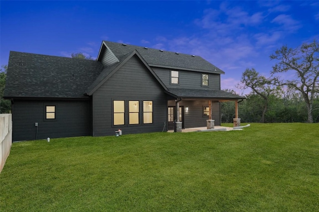280 Bali Hai Ln, Bastrop, TX 78602 - back of property at dusk featuring a patio and roof with shingles