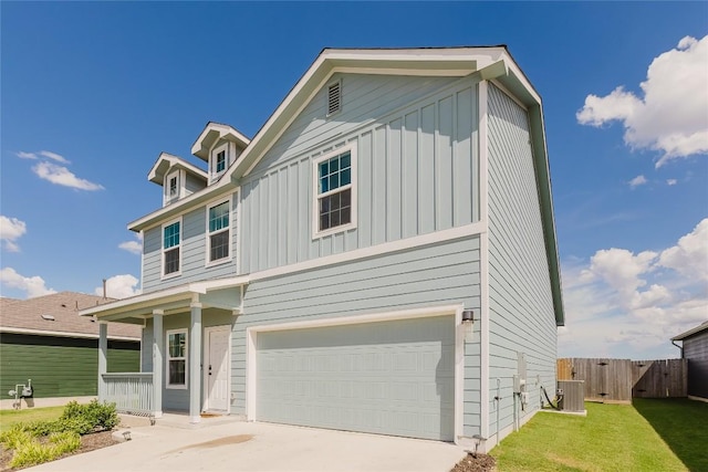 504 N Thunderstorm Ave, Lockhart, TX 78644 - view of front of property featuring board and batten siding, a garage, driveway, a porch, and a gate