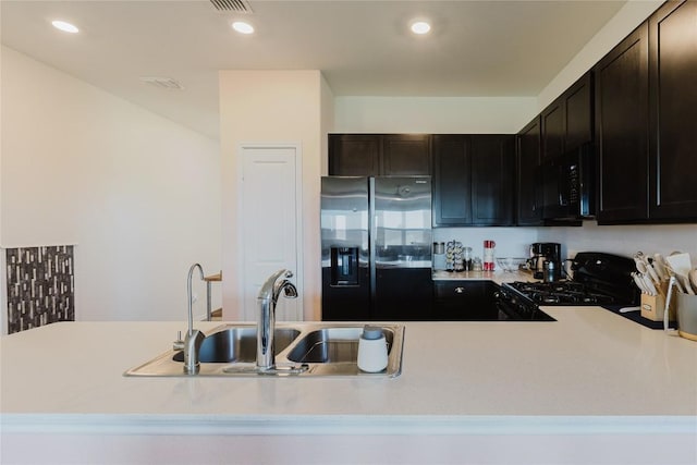 504 N Thunderstorm Ave, Lockhart, TX 78644 - kitchen featuring black appliances, light countertops, and recessed lighting