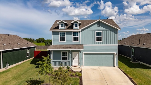 504 N Thunderstorm Ave, Lockhart, TX 78644 - traditional-style home featuring board and batten siding, covered porch, an attached garage, driveway, and a front yard