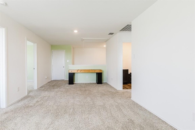 504 N Thunderstorm Ave, Lockhart, TX 78644 - unfurnished living room featuring attic access, carpet flooring, and recessed lighting