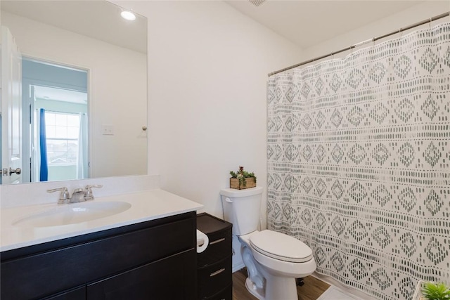 504 N Thunderstorm Ave, Lockhart, TX 78644 - bathroom featuring vanity, a shower with curtain, and wood finished floors