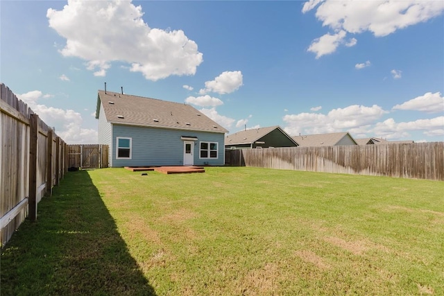 504 N Thunderstorm Ave, Lockhart, TX 78644 - back of property with a fenced backyard and a deck