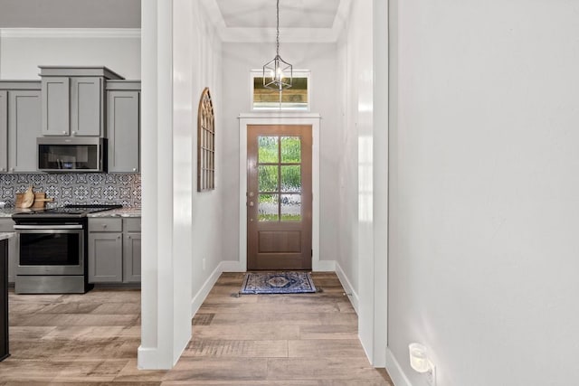 4 Country Ct, Wimberley, TX 78676 - entryway with light wood-style flooring and ornamental molding