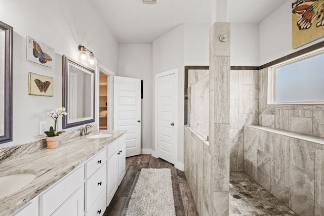 4 Country Ct, Wimberley, TX 78676 - full bath featuring walk in shower, double vanity, and wood finished floors