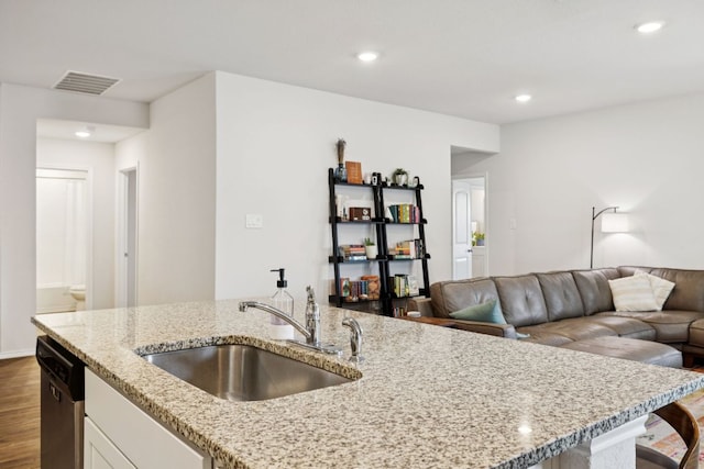 1004 Norway, Seguin, TX 78155 - kitchen with light stone countertops, dark wood finished floors, dishwasher, white cabinets, and recessed lighting