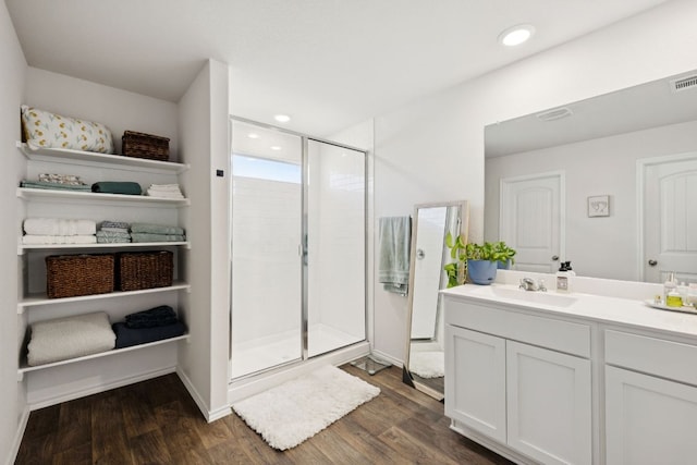 1004 Norway, Seguin, TX 78155 - bathroom featuring vanity, a stall shower, wood finished floors, and recessed lighting