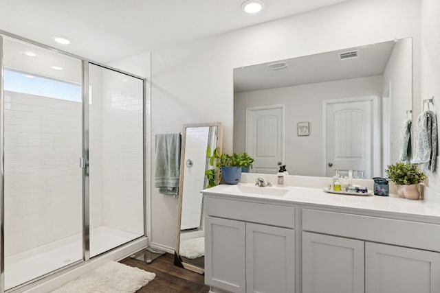 1004 Norway, Seguin, TX 78155 - bathroom with vanity, a shower stall, wood finished floors, and recessed lighting
