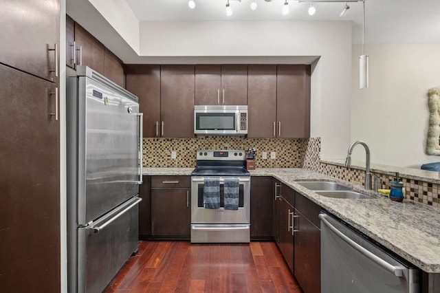 1320 Robert Browning St Unit 208, Austin, TX 78723 - kitchen with appliances with stainless steel finishes, dark wood finished floors, dark brown cabinets, tasteful backsplash, and light stone counters