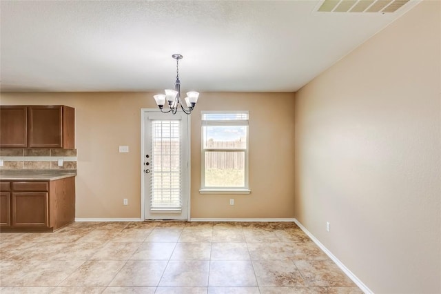 9104 Single Bend Trl, Temple, TX 76502 - unfurnished dining area featuring a chandelier and light tile patterned floors