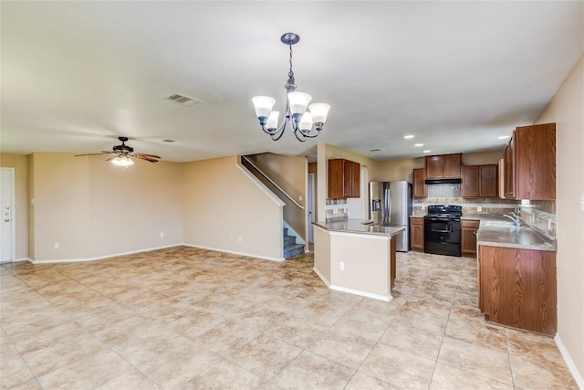 9104 Single Bend Trl, Temple, TX 76502 - kitchen with black electric range, stainless steel fridge, open floor plan, a chandelier, and brown cabinets