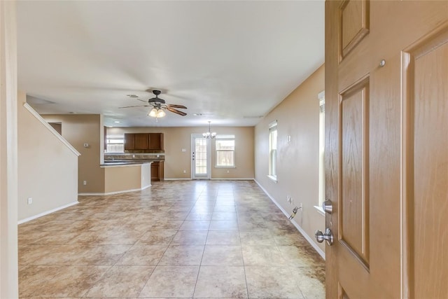 9104 Single Bend Trl, Temple, TX 76502 - unfurnished living room featuring a ceiling fan, a chandelier, and light tile patterned flooring