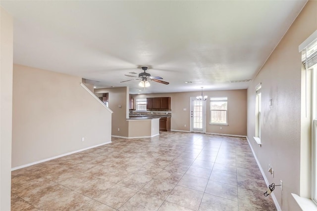 9104 Single Bend Trl, Temple, TX 76502 - unfurnished living room with a ceiling fan, a chandelier, and light tile patterned floors