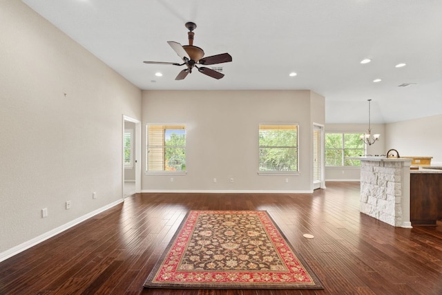 1403 Adam Ave, Burnet, TX 78611 - unfurnished living room featuring a ceiling fan, dark wood-style floors, a chandelier, and recessed lighting