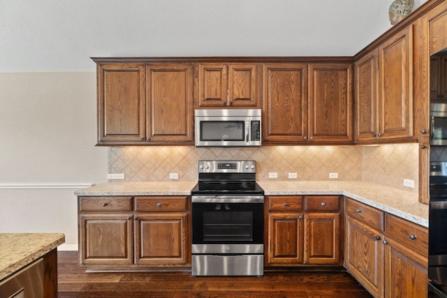 1403 Adam Ave, Burnet, TX 78611 - kitchen with stainless steel appliances, dark wood-style flooring, and decorative backsplash