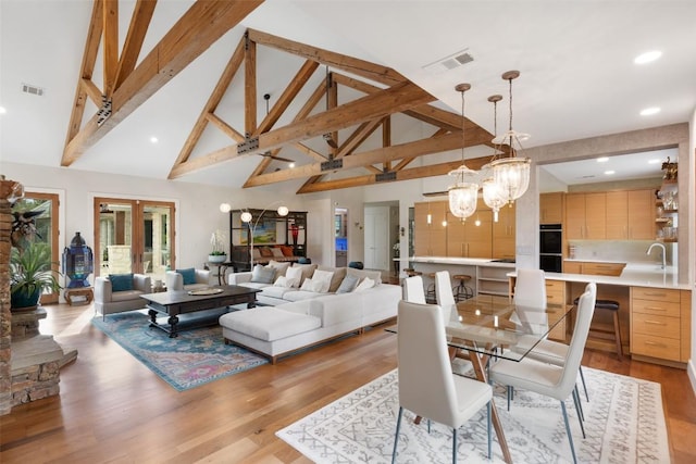 601 Crystal Creek Dr, Austin, TX 78746 - living room featuring high vaulted ceiling, light wood-style flooring, beam ceiling, recessed lighting, and a chandelier